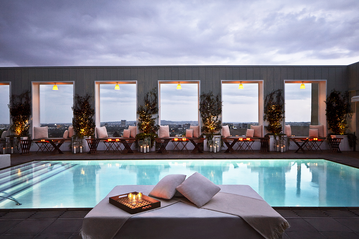 A pool and rooftop bar at twilight