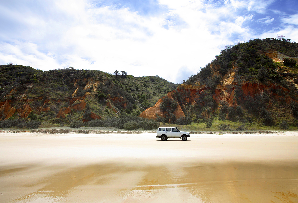4WD passing Red Rock along 75 mile beach on Fraser Island